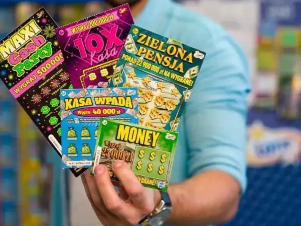 Dłoń trzyma kilka kolorowych zdrapek z napisami "Maxi Cash Party", "10X Kasa", "Zielona Pensja", "Kasa wpada" i "Money".